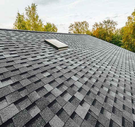 A grey asphalt roof with a skylight in Wisconsin 