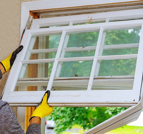 An Infinity window contractor installs a new white vinyl window on a home in Wisconsin 