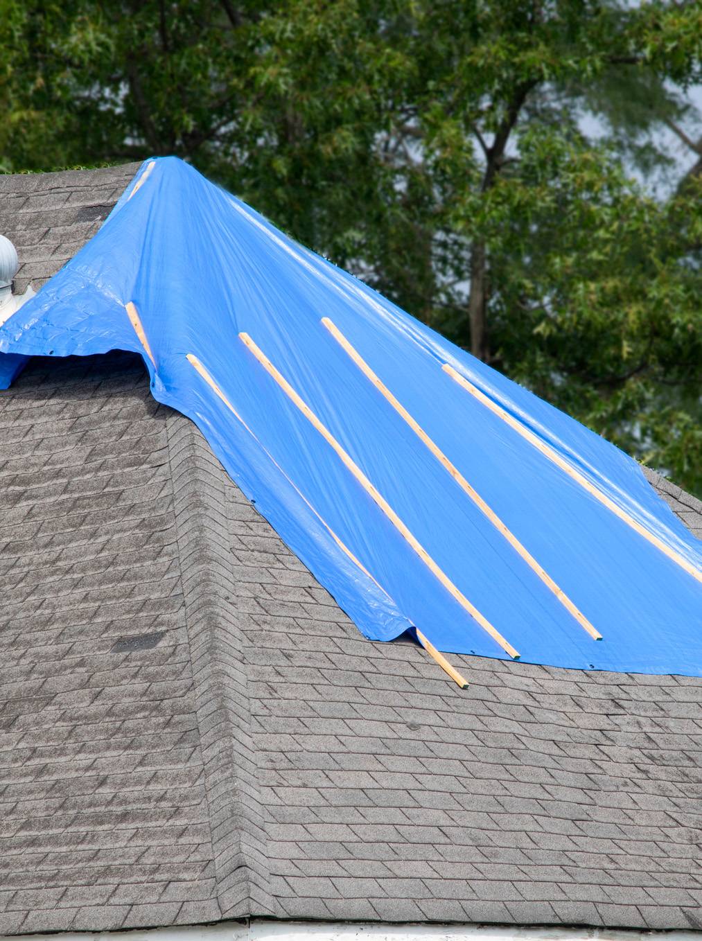 Tarp on roof to stop roof leaks