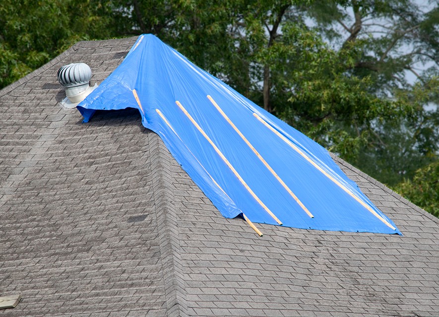 Roofer applying emergency repairs after storm in Wisconsin